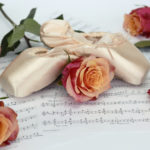 A rose stem on sheet music