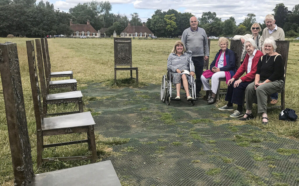 Members mostly seated at The Jurors, art for Magna Carta at Runnymede